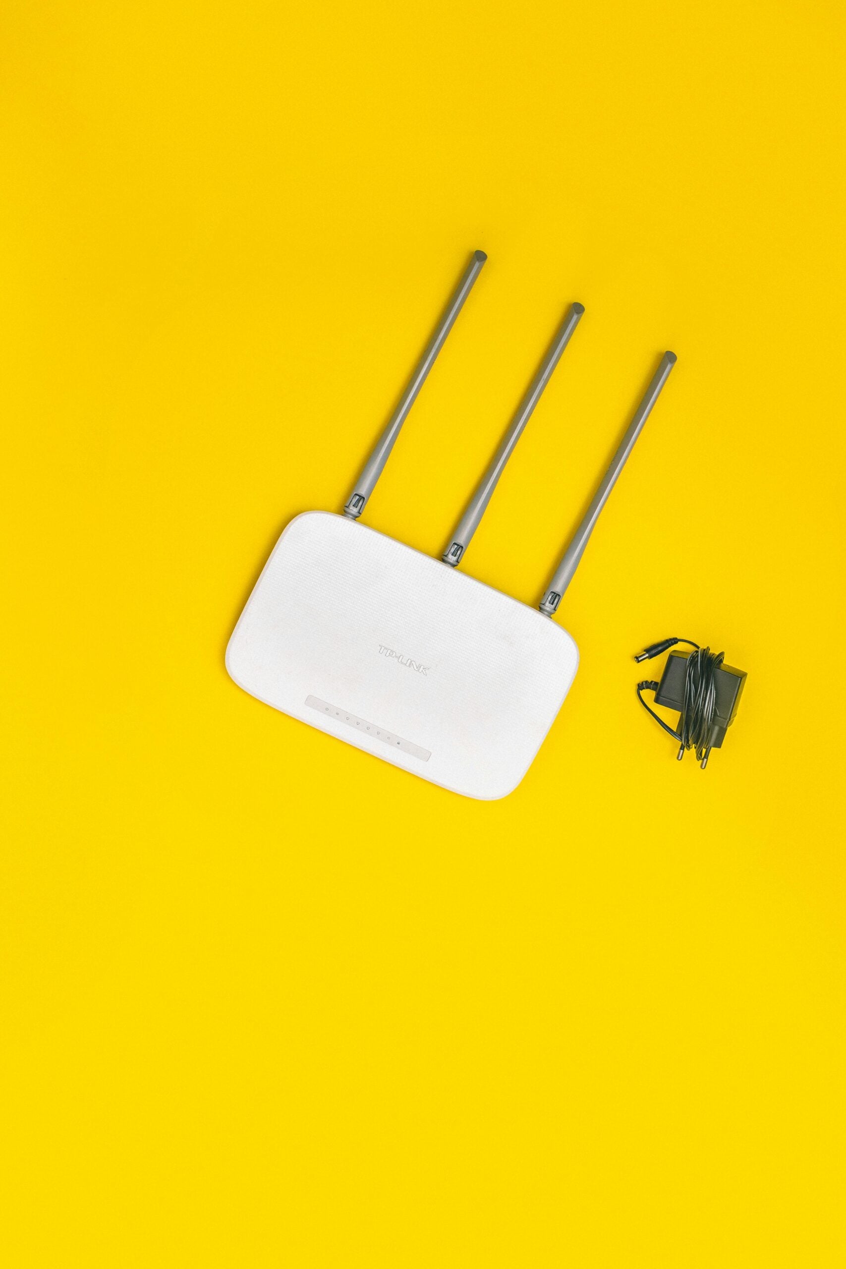 WiFi-Performance-Secrets-to-Boost-Your-Business-Productivity-scaled Wi-Fi device with yellow background