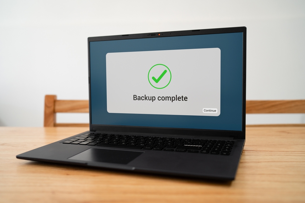 BackupCompleteNotificationMessageOnLaptopScreen Backup complete notification message on laptop screen.