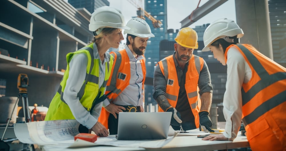 PortraitOfDiverseMultiethnicTeamOfConstructionWorkersHavingAn Company Crew Discussing It Solutions