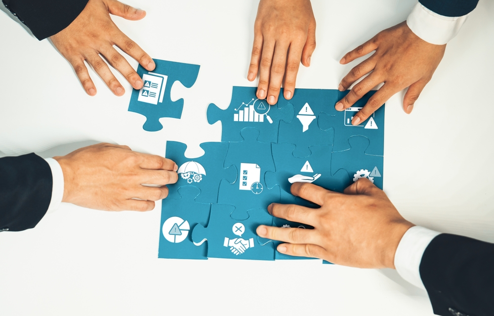 Topviewpanoramabannerofbusinessteamassemblingjigsawpuzzle | enstep technology solutions Risk Assement Puzzle for Businesses