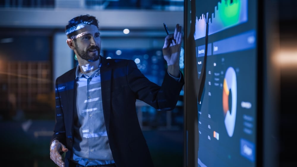 Businessman Shows IT Data to Group