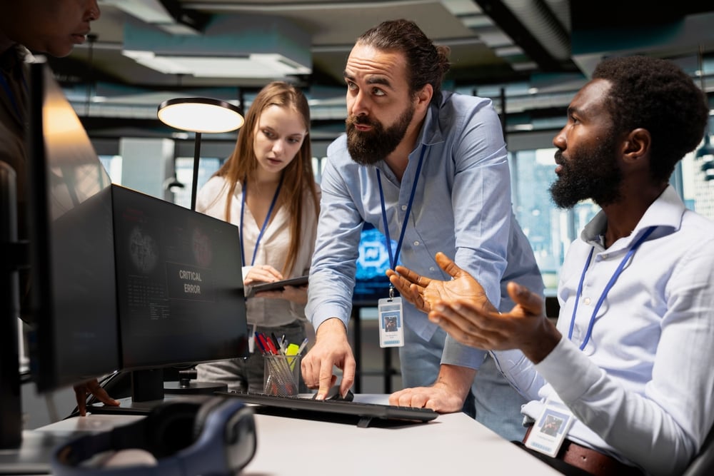 TeamOfProgrammersResolvingCriticalErrorAlertOnScreenIn it problem being solved