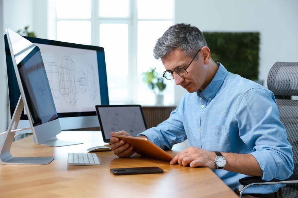 EngineerWorkingWithDevicesAtTableInOffice business growth, IT support, managed IT services, technology infrastructure, cybersecurity, network management, system monitoring, operational efficiency, cloud solutions, IT strategy