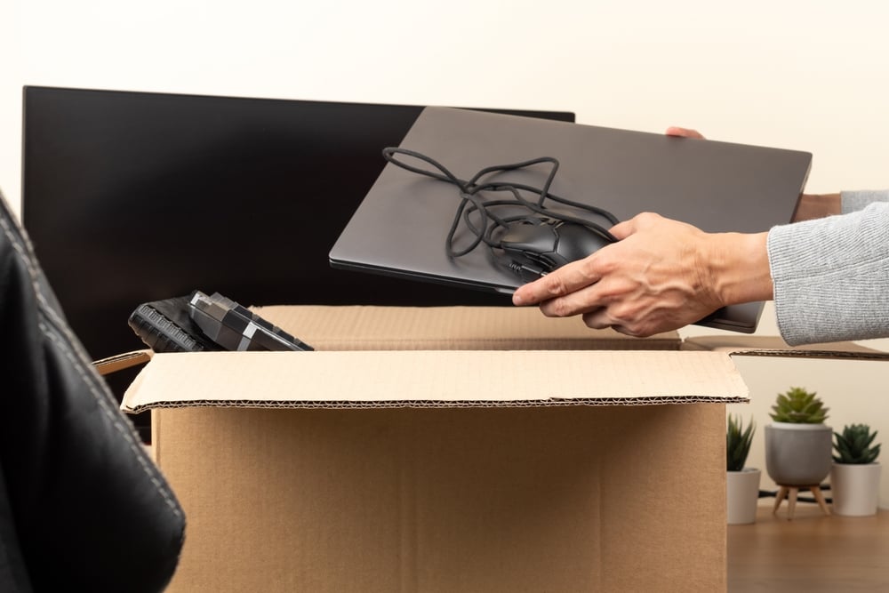 Woman,Hands,Put,Old,Laptop,Computer,In,Cardboard,Box,With outdated tech