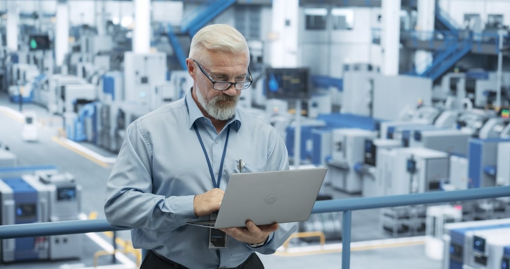 MiddleAgedEngineerMonitoringAndAnalyzingConditionsAtAnAutomated manufacturing it support